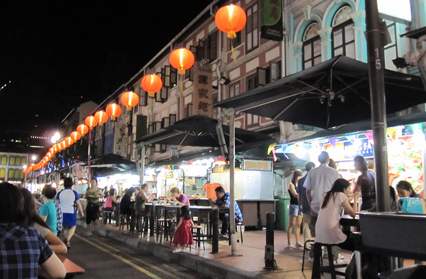 Lanterns and people eating at food stalls in Chinatown 