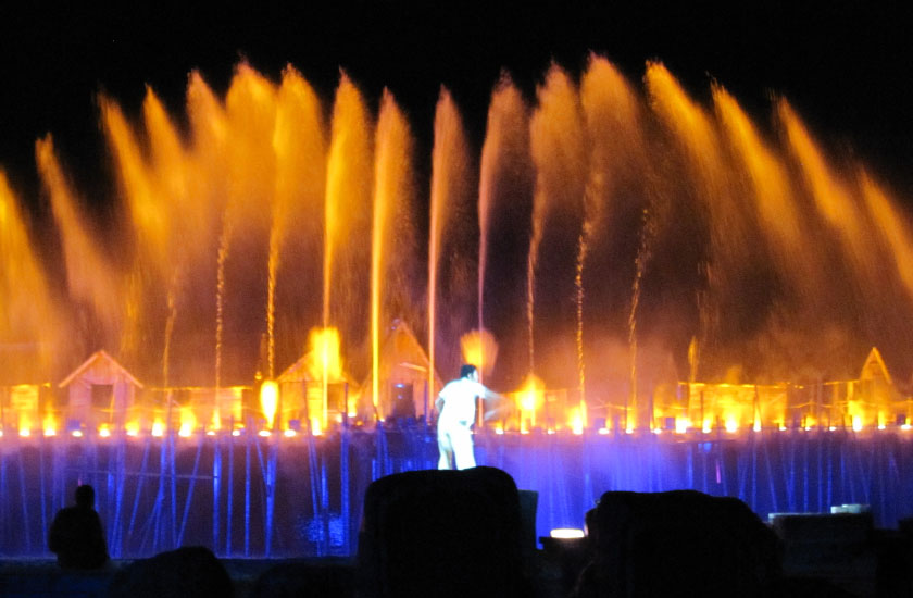 Man singing at Magical light water laser show performance Songs of the Sea