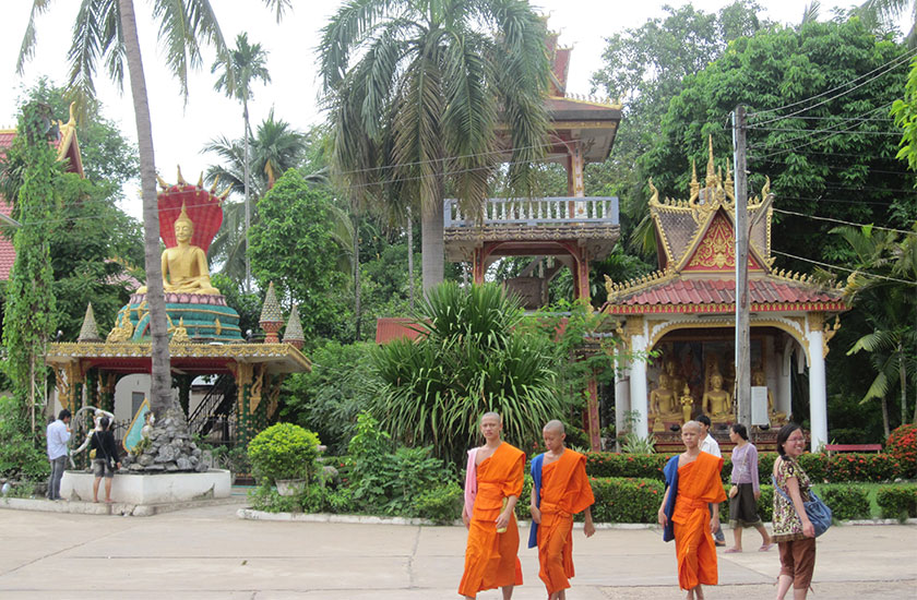 Monks at Wat That Luang Tai Garden in Vientiane, Laos