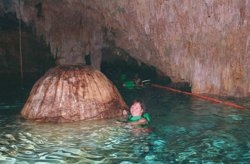 Swimming in a cave at Rio Secreto National Park during an excursion from Cozumel Mexico