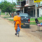 Monk riding bicycle in Laos