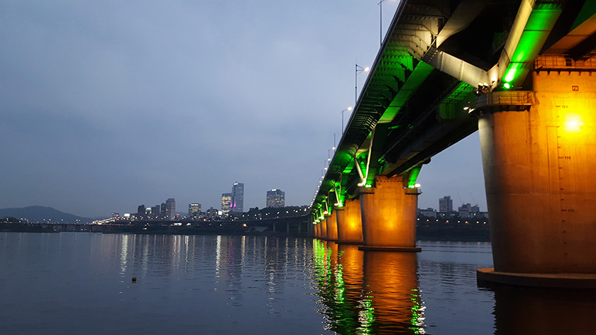 Lit up bridge spanning over Han River at night in Korea