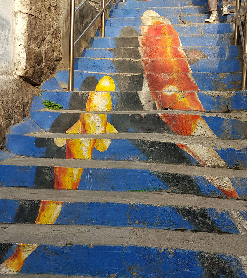 Koi fish mural and other public art by local artist at Ihwa Mural Village in Seoul